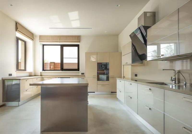 Bright and spacious modern kitchen interior featuring sleek cabinets and a central kitchen island